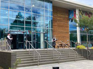 Two Pipers playing at the front door of the International School Aberdeen